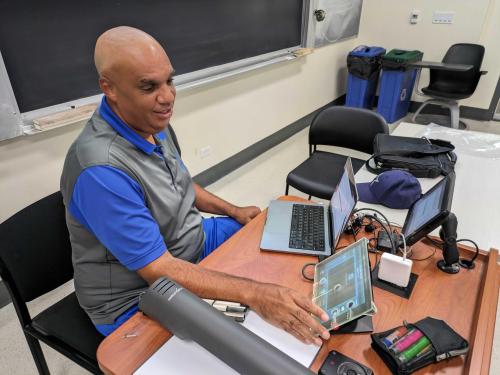 Professor Seth Clark using the 3D printed screen overlay